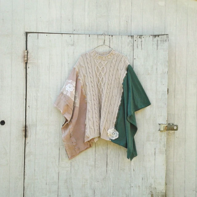 an ugly sweater hanging on a white wooden door