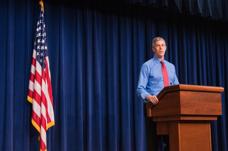 a man standing at a podium giving a speech