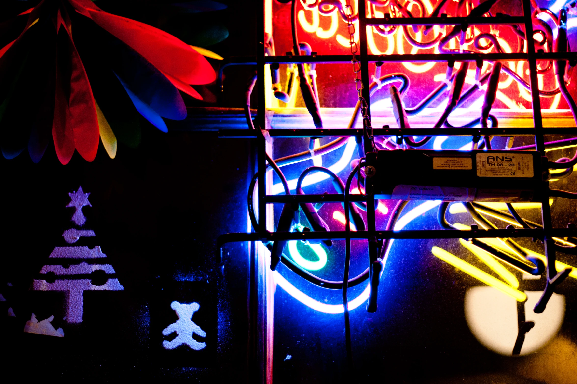 neon signs hanging off the side of a building