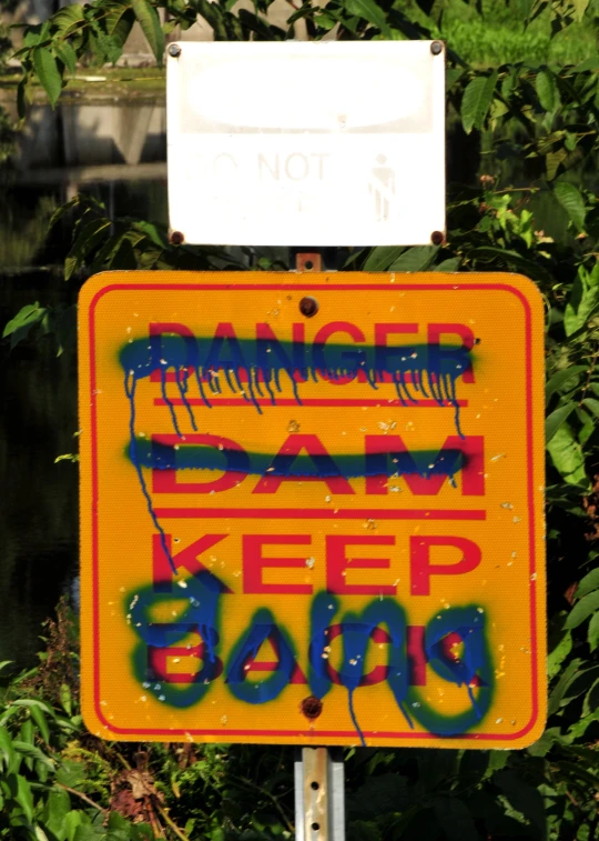a street sign with graffiti saying keep going