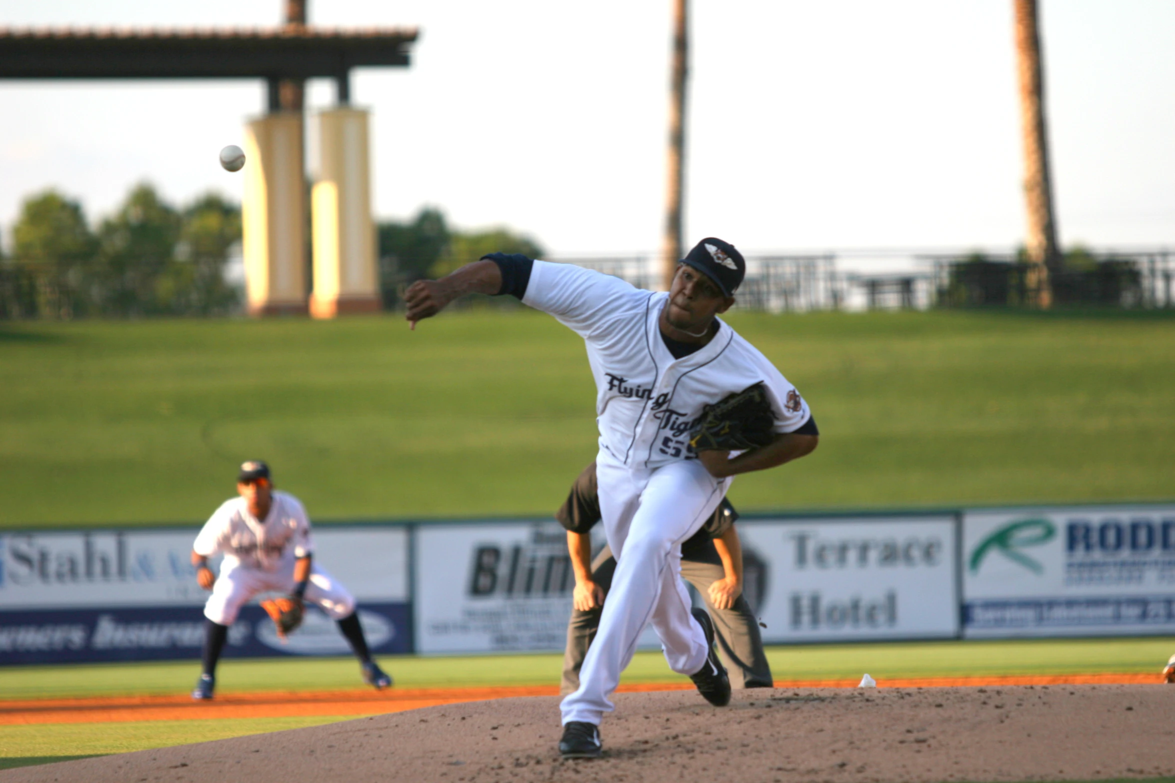 a baseball player pitching a baseball from the mound