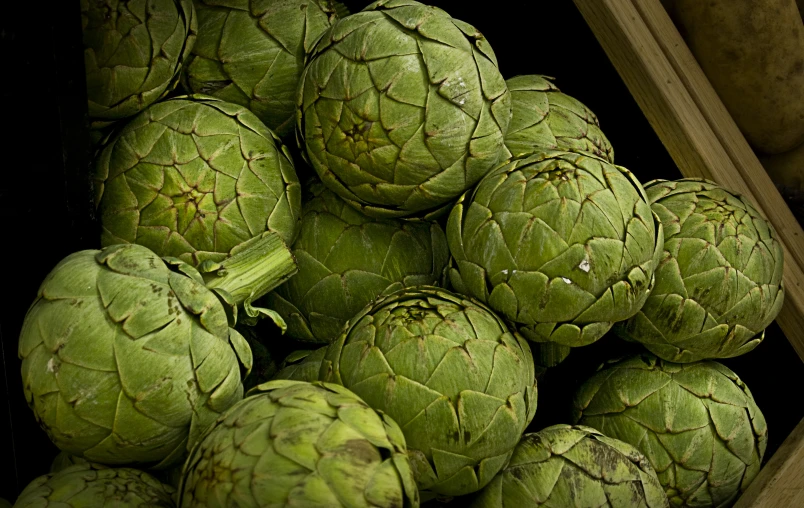 some green artichokes piled on top of each other