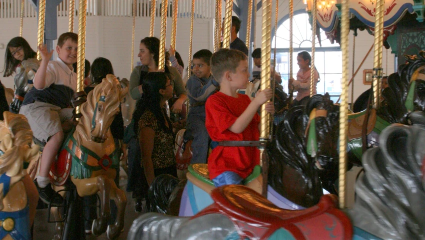 the children are playing on a merry go round