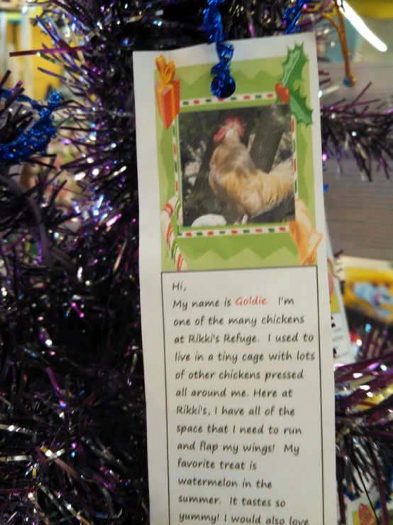 a card attached to a christmas tree that's decorated with a holiday ornament