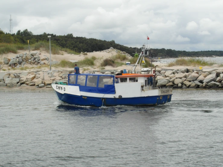 a large white and blue boat is traveling on the water