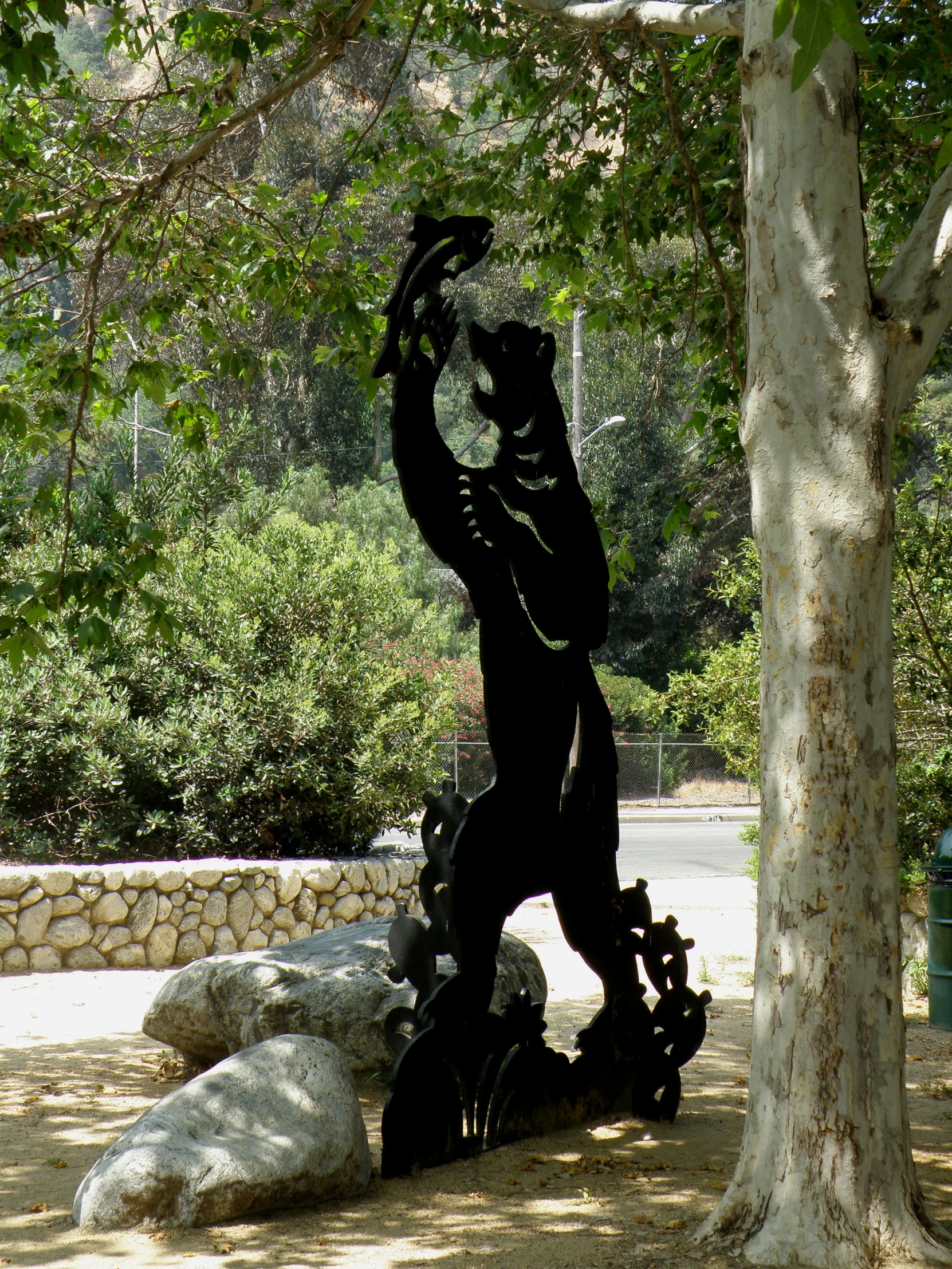 a statue is positioned in the middle of a forest