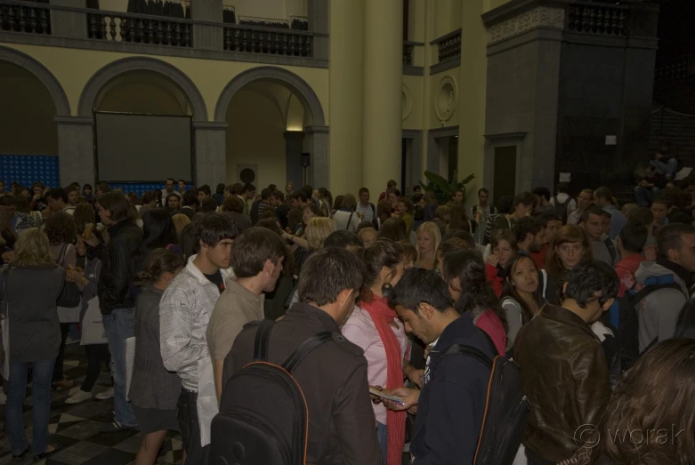 a large group of people standing around each other