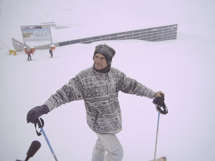 a man with two skis and a ski pole
