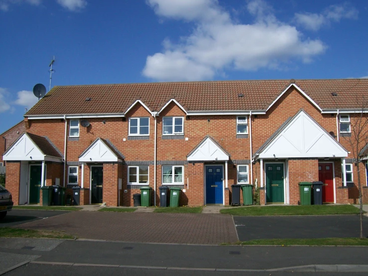 several brick apartment buildings with several different color doors