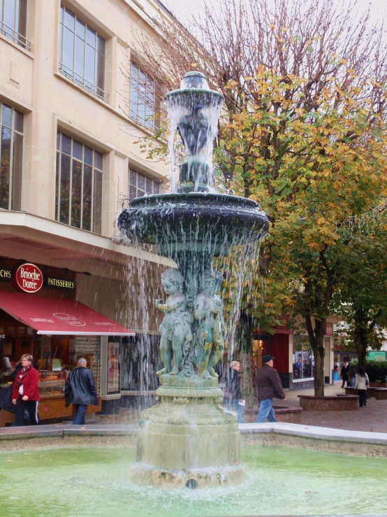 a fountain in front of buildings in an urban area