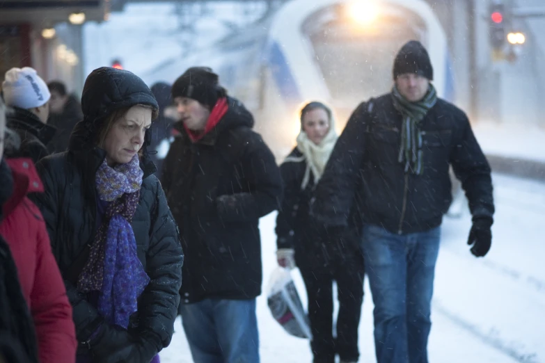 a group of people standing on a snowy street