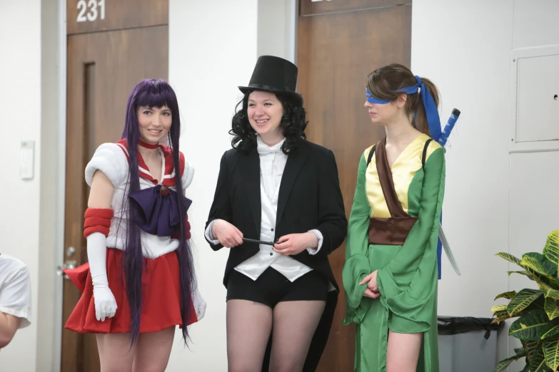 three young people in costume standing next to each other