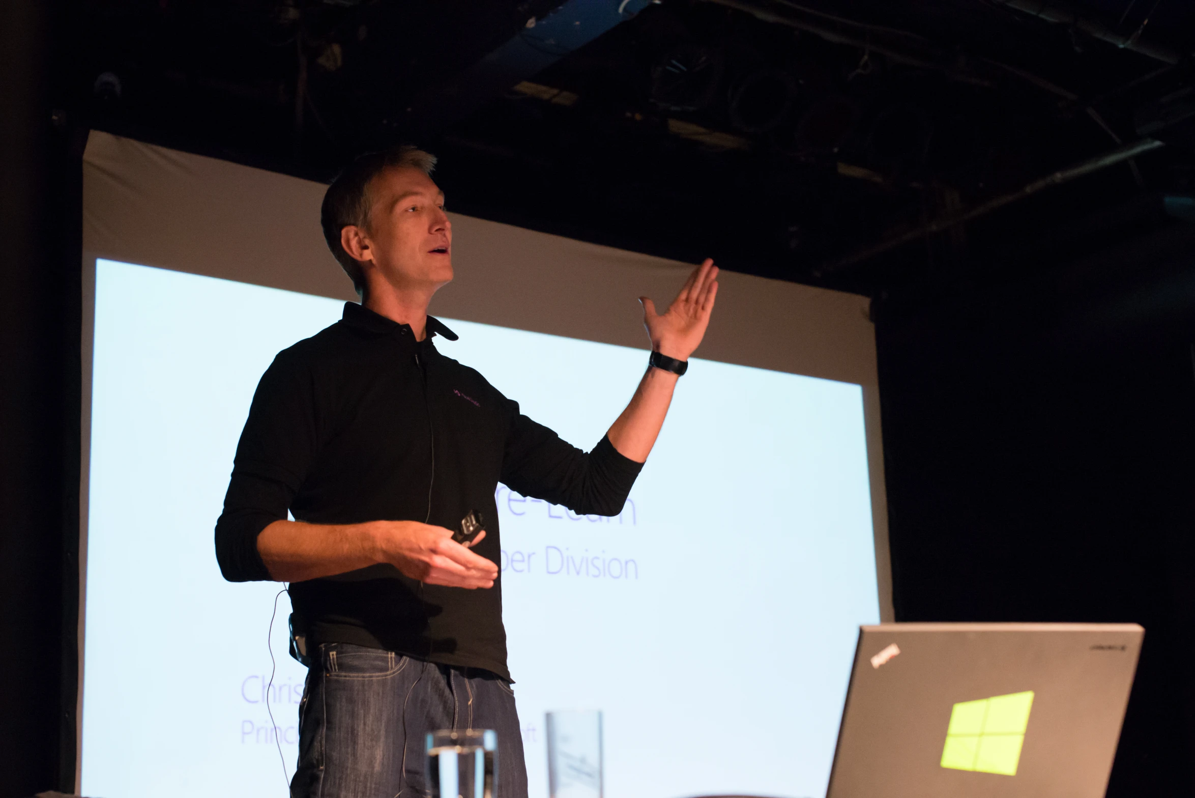 a man on stage is giving a lecture