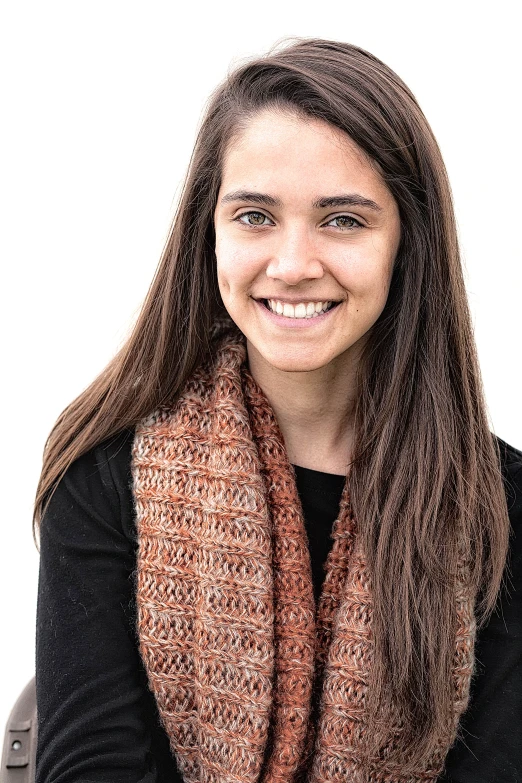 a woman with a smile and brown scarf