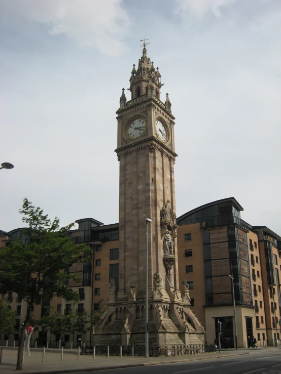 an ancient clock tower is on the corner of a street