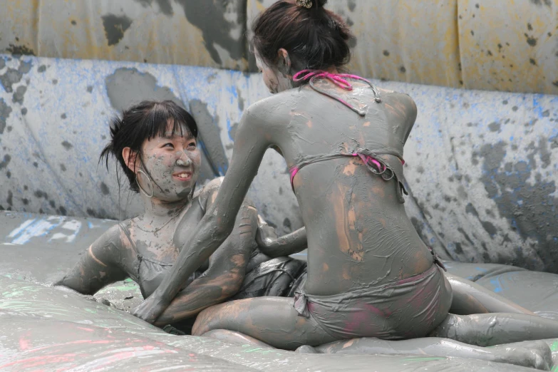 two women with body paint sit on top of each other