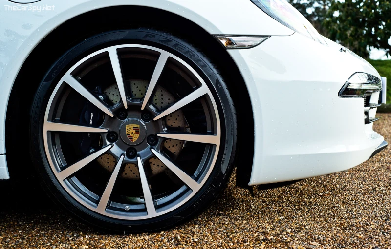 a white sports car parked on a gravel road