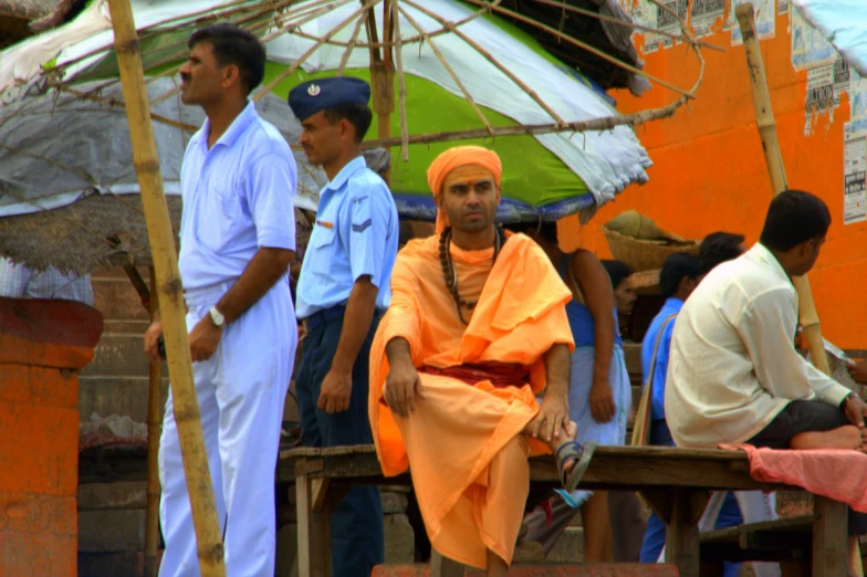 a monk standing by a crowd of people