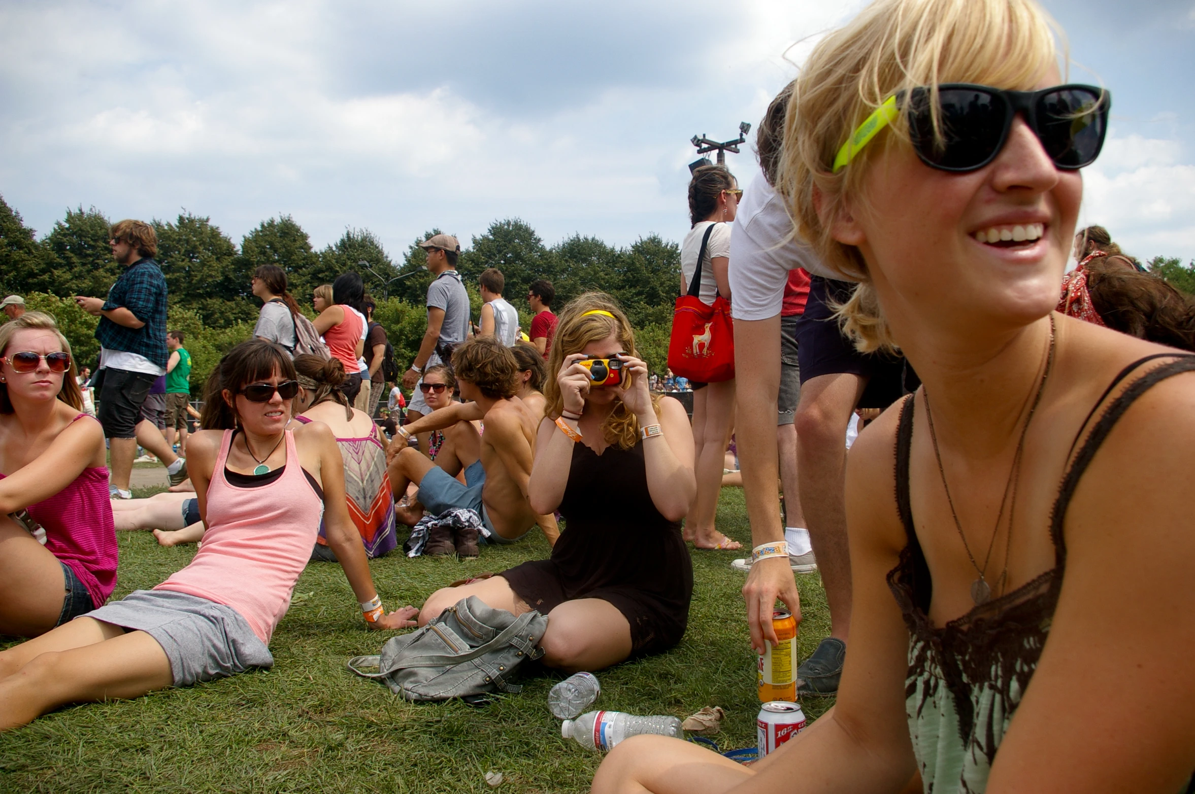 many people sitting on the grass and in glasses