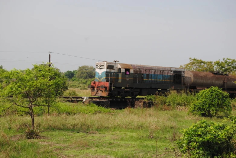 an old train traveling through the country side