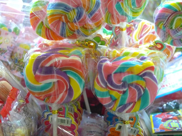lollipops and candy sticks sit on display in a store