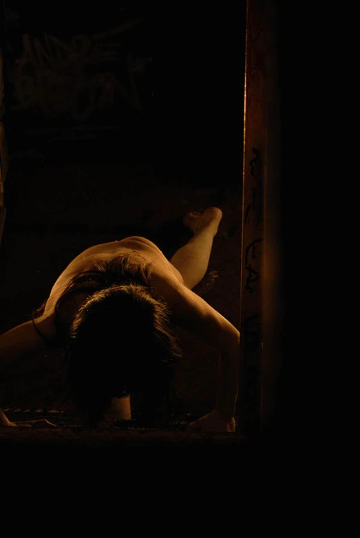  woman bending over in the dark of night