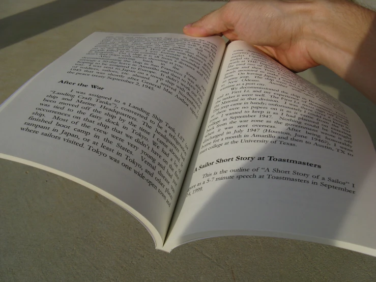 a closeup view of the hand of a person holding a book