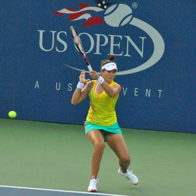 a woman on the tennis court with a racquet