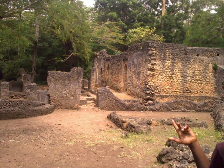 a man is pointing his fingers at the ruins