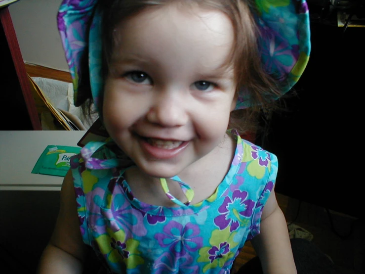 a young child with blue eyes smiles for the camera