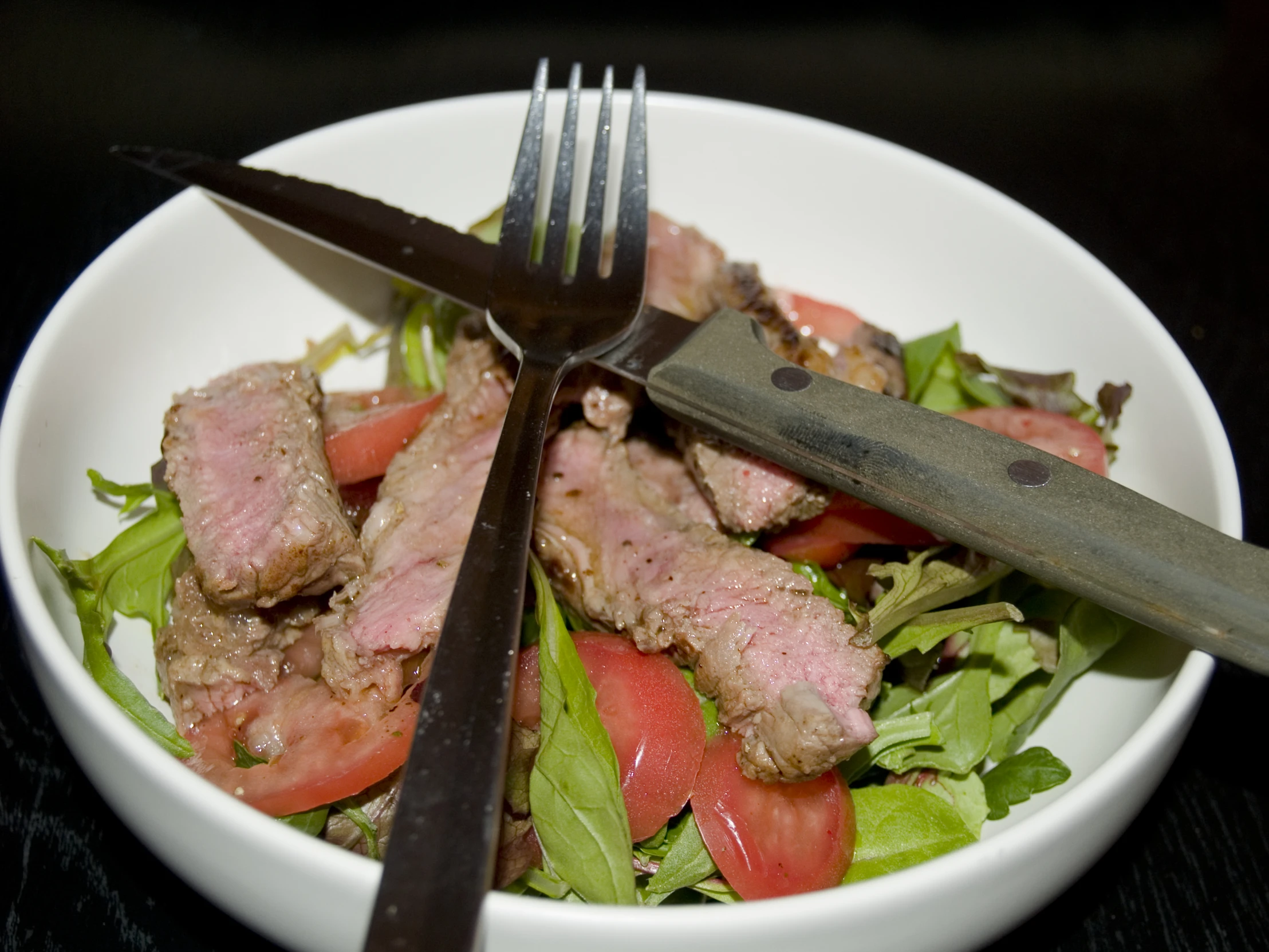 steak salad with lettuce and tomatoes in bowl