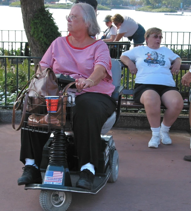 a woman is sitting in a motorized walker