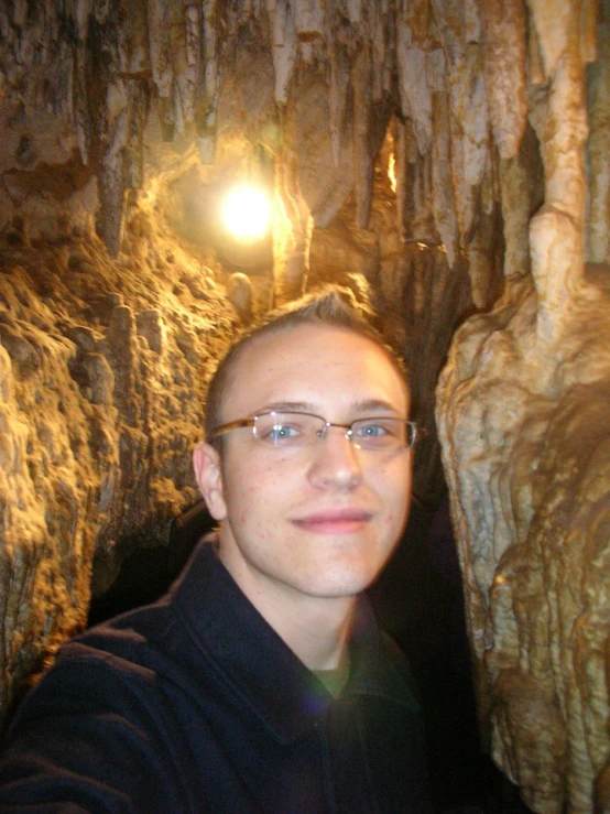 a person in a cave looking at the camera