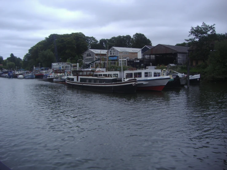 two boats sitting on the water next to a lot of houses