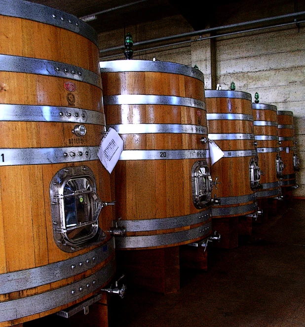 a row of barrels sit in a room lined up