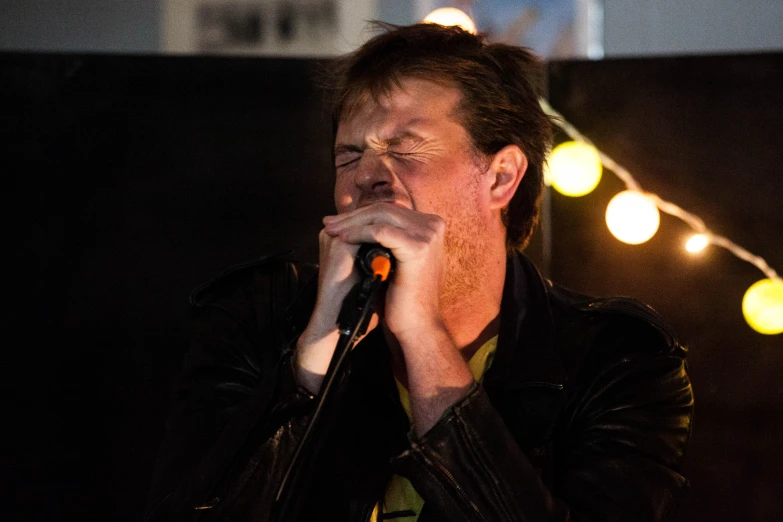 a man with headphones on singing into a microphone