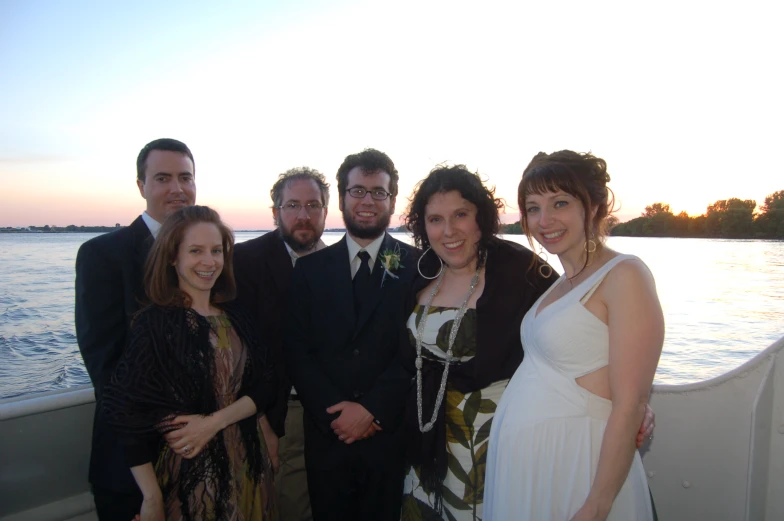 the men and women are posing on the boat