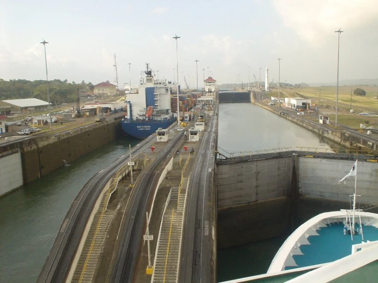 a ship sitting in the middle of a large open canal