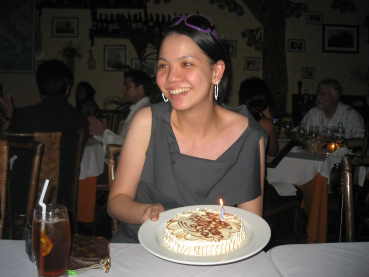 a smiling woman holding a plate with food on it