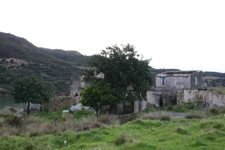 there is a building in the grass and trees