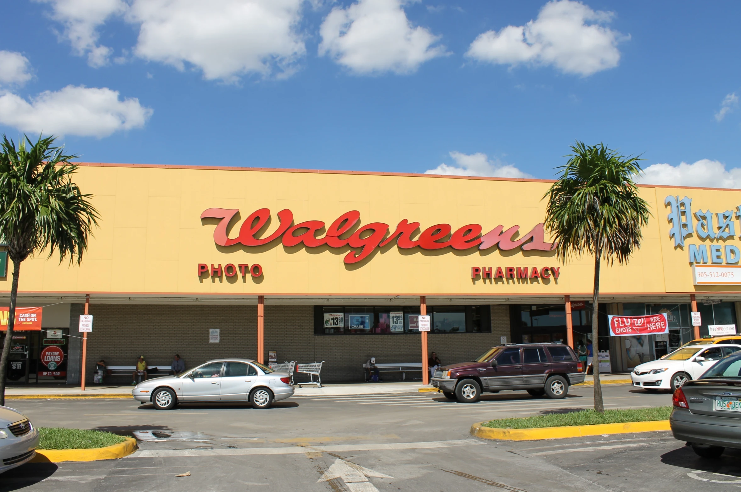 a walgreens store with several cars parked on the parking lot