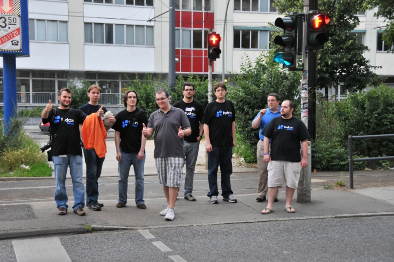 people standing on a corner of a city street