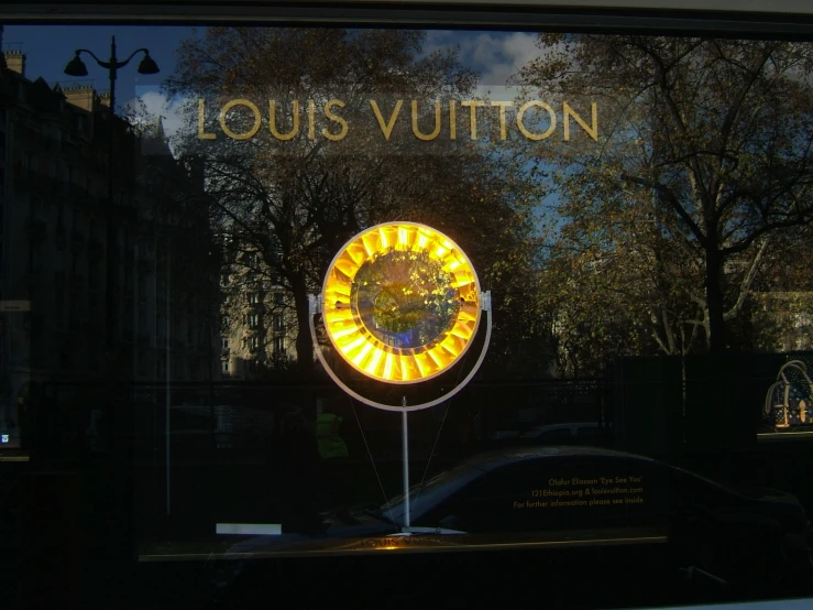 reflection in a store window of an ornamental circular light