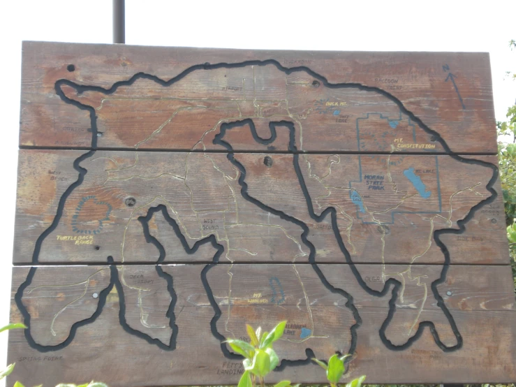 a wooden sign with a map of the country