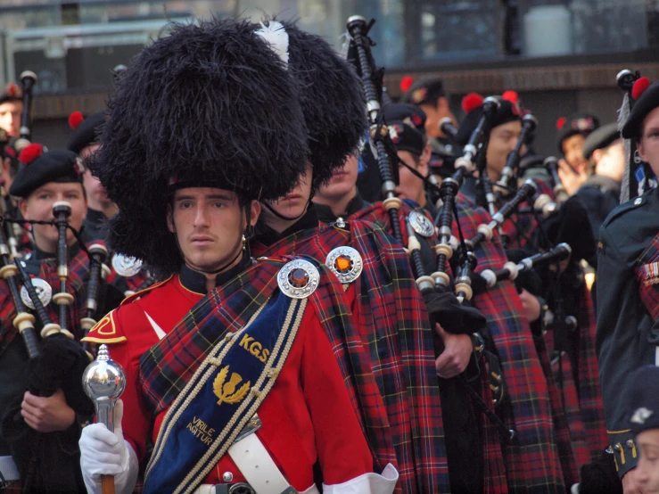 a large marching band wearing plaid shirts