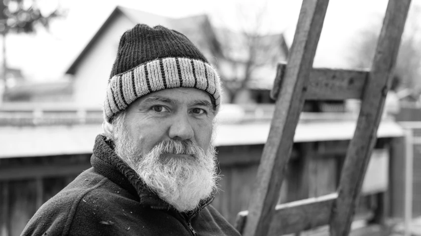 a man is standing next to a ladder