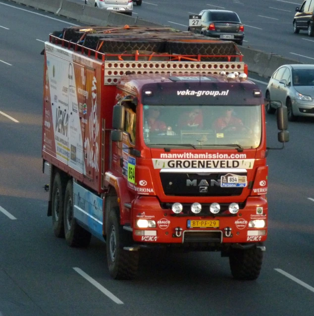 a large red truck on a busy city road