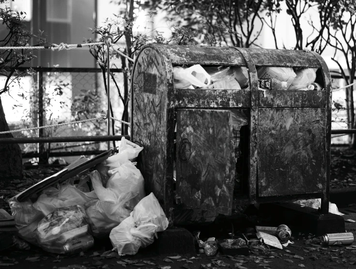 some garbage sitting on the ground by a fence