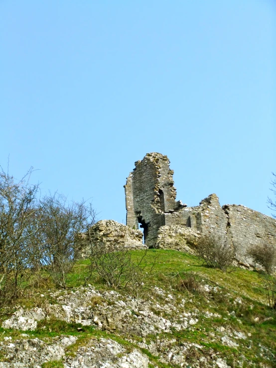 the ruins are on top of the rocky hill