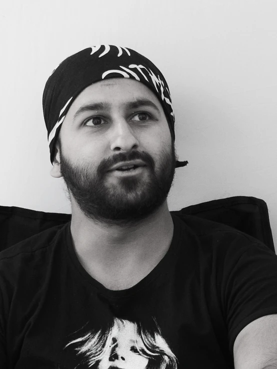 man with beard and bandana on sitting down